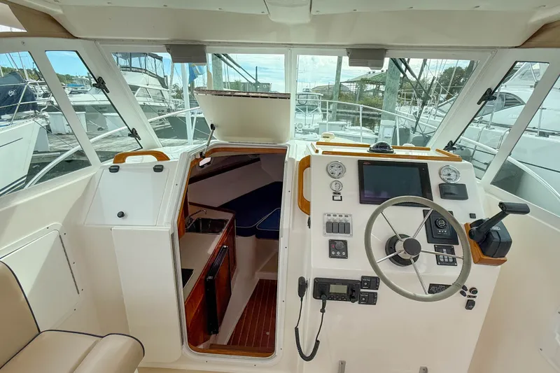 Slide: The Image of 2004 Hunt Yachts Surfhunter 29 helm with navigation instruments and cabin entrance. - 9