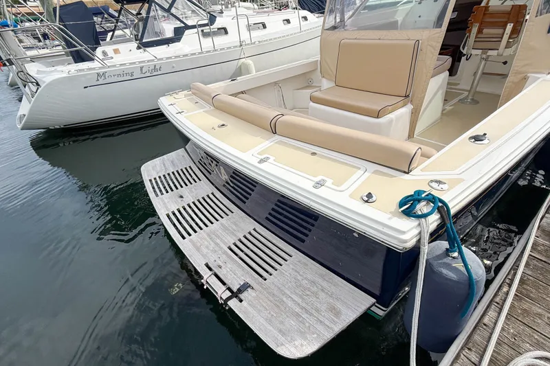 Slide: The Image of 2004 Hunt Yachts Surfhunter 29 docked, featuring spacious seating and swim platform. - 2