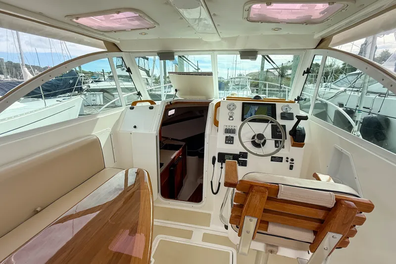 Slide: The Image of 2004 Hunt Yachts Surfhunter 29 cockpit with steering wheel, navigation controls, and seating. - 7