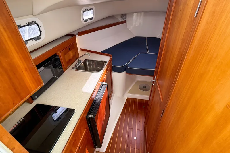 Slide: The Image of Interior of 2004 Hunt Yachts Surfhunter 29 with kitchenette and cozy seating area. - 15