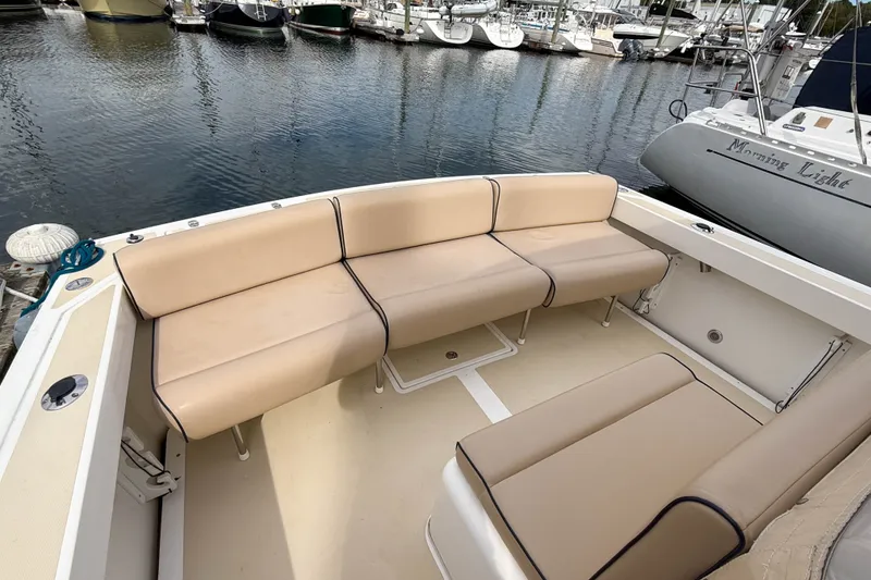 Slide: The Image of 2004 Hunt Yachts Surfhunter 29 with beige seating, docked at a marina. - 4