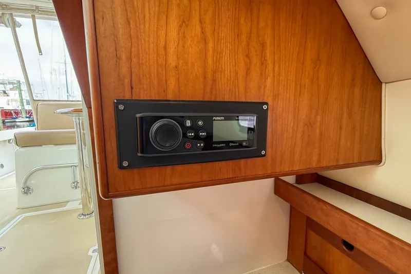 Slide: The Image of 2004 Hunt Yachts Surfhunter 29 interior with Fusion stereo system on wooden panel. - 18