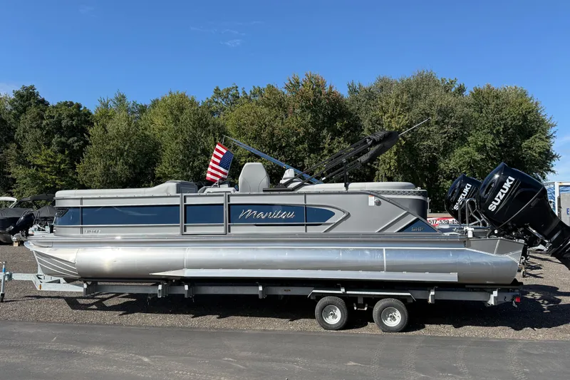 Slide: The Image of 2027 Manitou Encore 25 RF Dual pontoon boat on trailer, with Suzuki engines. - 3