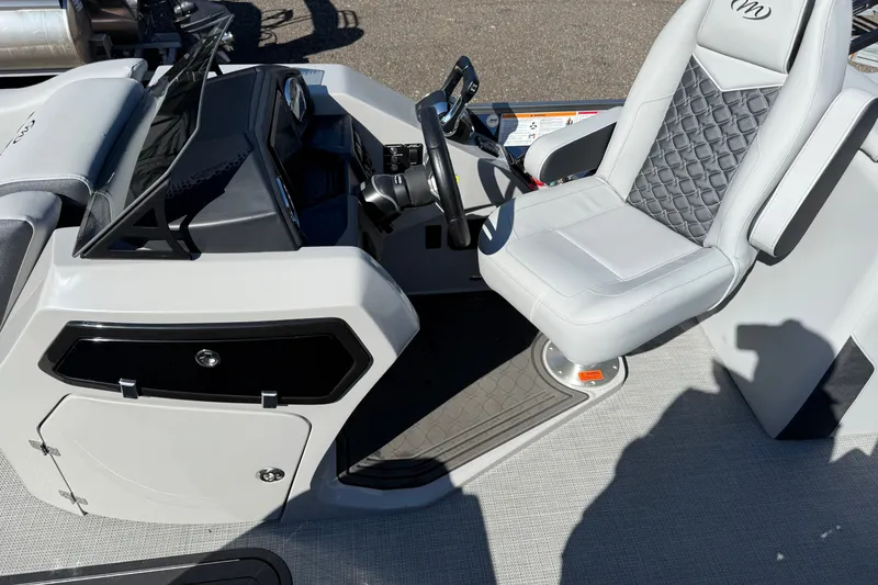 Slide: The Image of 2027 Manitou Encore 25 RF Dual boat cockpit with modern steering and seating. - 23