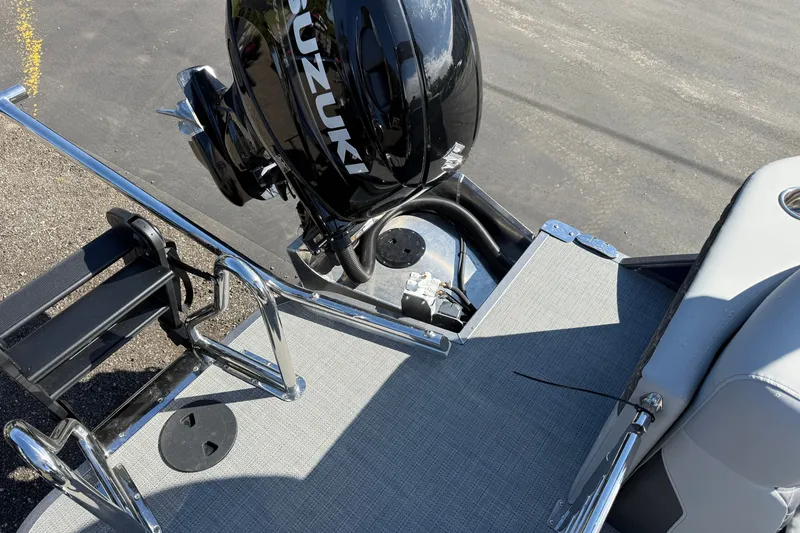 Slide: The Image of 2027 Manitou Encore 25 RF Dual boat with Suzuki outboard motor and ladder. - 18