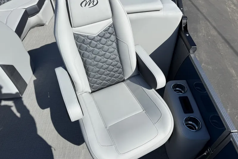 Slide: The Image of Luxurious seating on 2027 Manitou Encore 25 RF Dual pontoon boat with cup holders. - 22