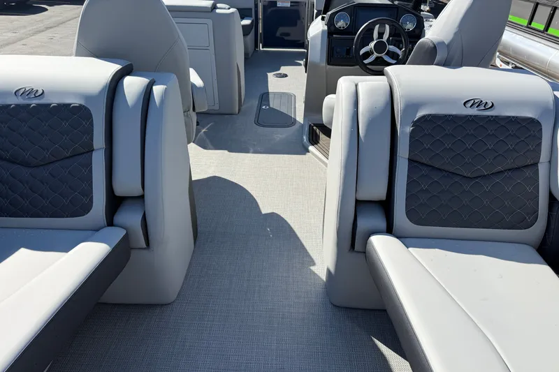 Slide: The Image of 2027 Manitou Encore 25 RF Dual boat interior with luxurious seating and modern dashboard. - 20