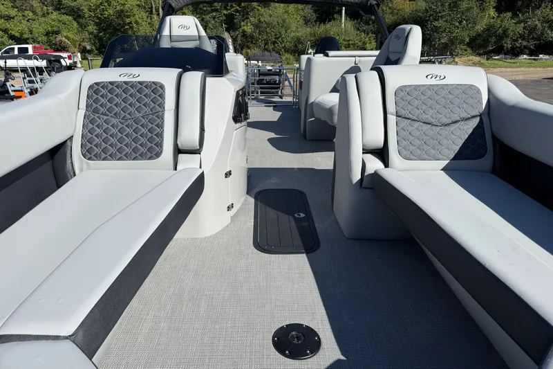 Slide: The Image of 2027 Manitou Encore 25 RF Dual pontoon boat interior with luxurious seating and modern design. - 9