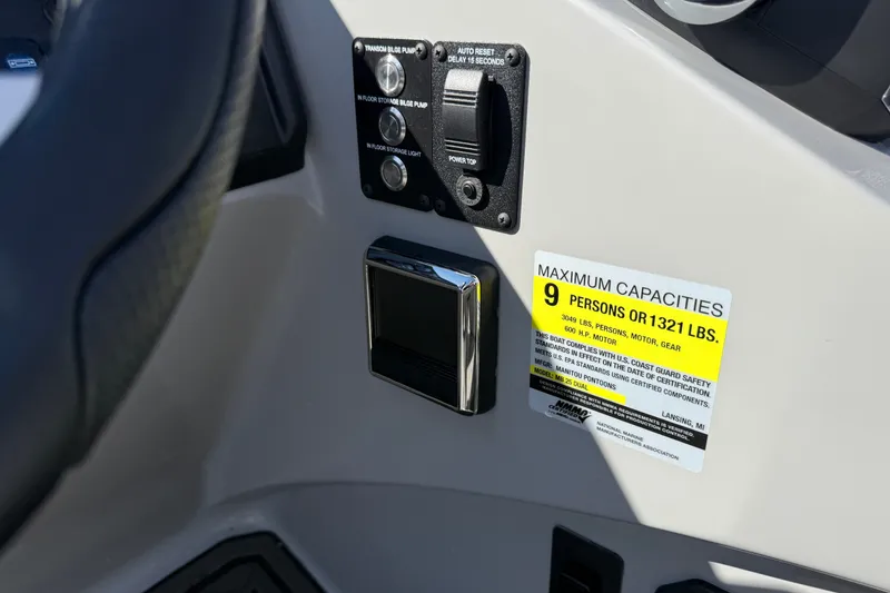Slide: The Image of Control panel and capacity label on 2027 Manitou Encore 25 RF Dual boat. - 25