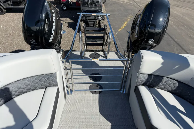 Slide: The Image of 2027 Manitou Encore 25 RF Dual pontoon boat with Suzuki engines, featuring plush seating. - 17