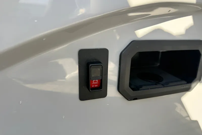 Slide: The Image of Switch and compartment on 2027 Manitou Encore 25 RF Dual boat exterior. - 26