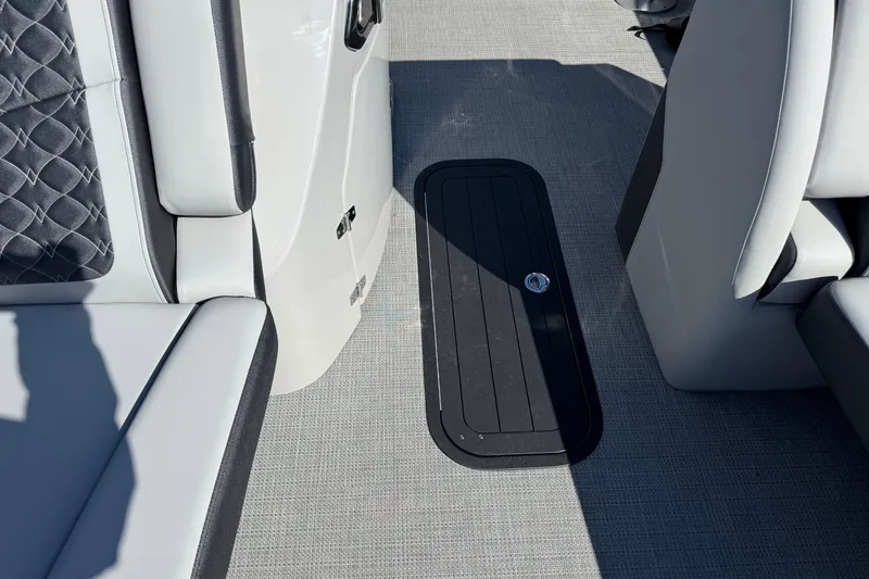 Slide: The Image of Interior of 2027 Manitou Encore 25 RF Dual boat, featuring sleek seating and flooring. - 10