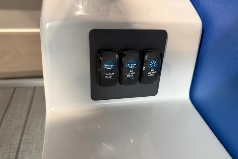 Slide: The Image of Control panel of 2027 Manitou Encore SL 25 with bilge and light switches. - 19
