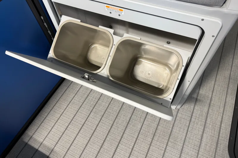 Slide: The Image of Storage compartment with dual bins in 2027 Manitou Encore SL 25 boat. - 14
