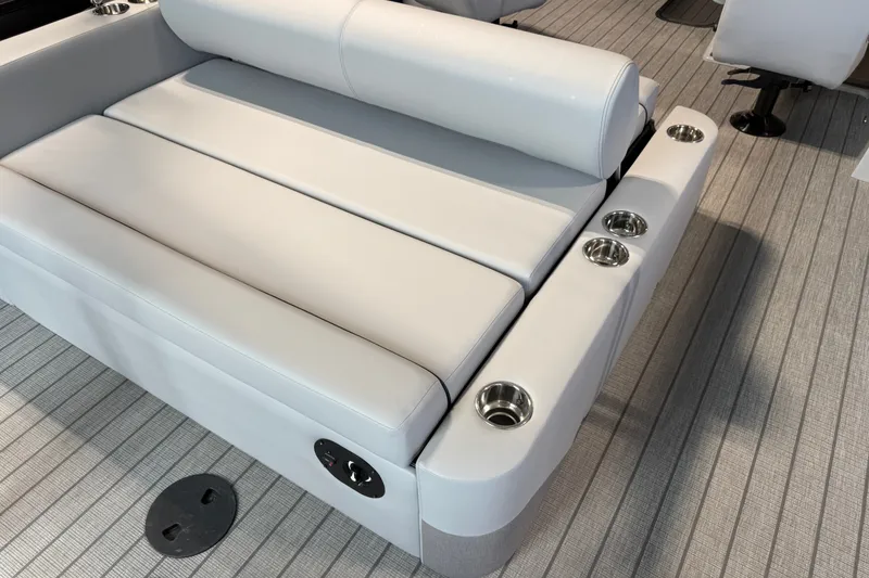 Slide: The Image of Luxurious seating on 2027 Manitou Encore SL 25 boat with integrated cup holders. - 25