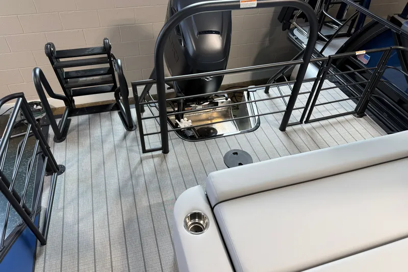 Slide: The Image of 2027 Manitou Encore SL 25 boat deck with seating and motor, showcasing modern design. - 23