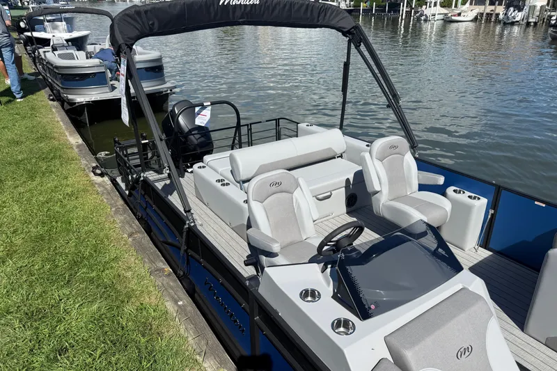 The Image of 2027 Manitou Encore SL 25 pontoon boat docked by a grassy shoreline. - 3
