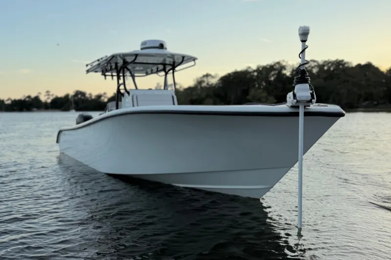 Slide: The Image of 2018 Yellowfin 32 Offshore boat on calm water at sunset. - 8