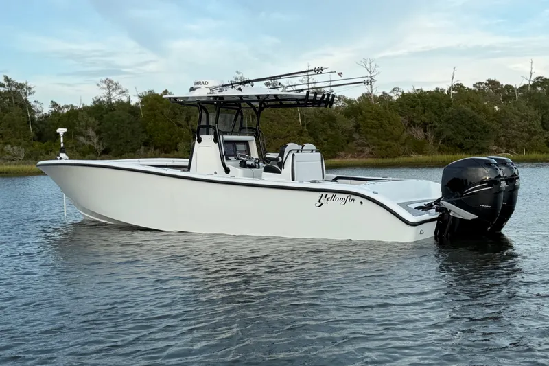 Slide: The Image of 2018 Yellowfin 32 Offshore boat on calm water, featuring dual outboard motors. - 6