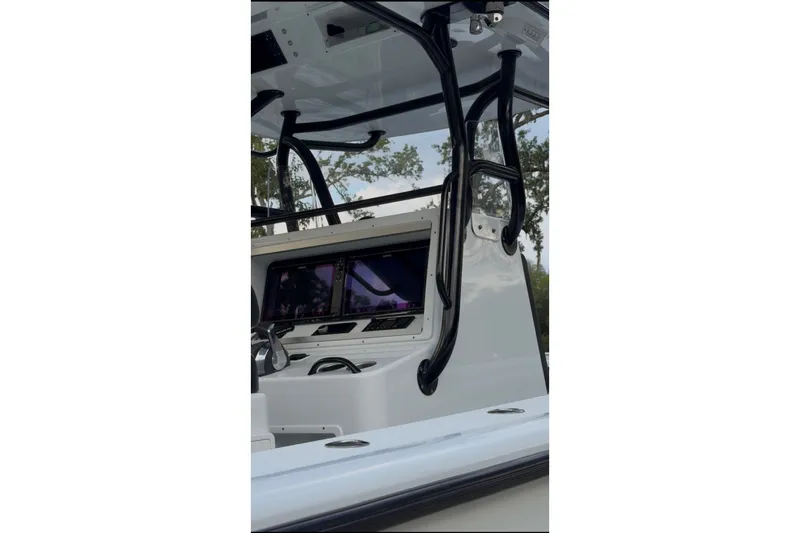 Slide: The Image of 2018 Yellowfin 32 Offshore boat console with navigation screens and sturdy black frame. - 11