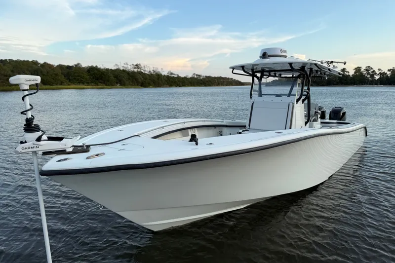 Slide: The Image of 2018 Yellowfin 32 Offshore boat on calm water, featuring Garmin equipment. - 7