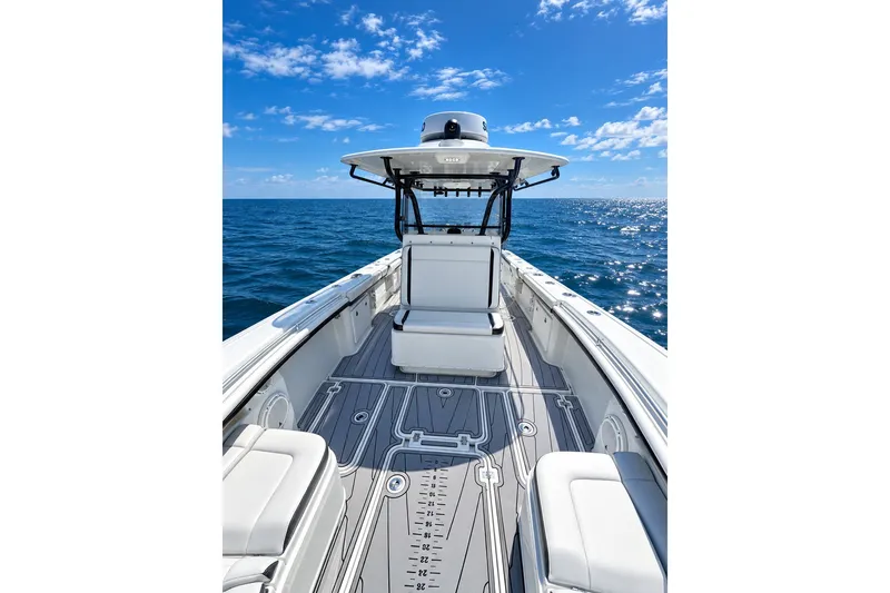 Slide: The Image of 2018 Yellowfin 32 Offshore boat on open sea under clear blue sky. - 9