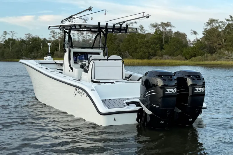 Slide: The Image of 2018 Yellowfin 32 Offshore boat with dual 350 horsepower engines on a calm waterway. - 3