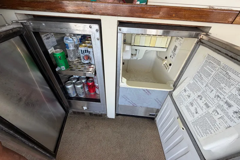 Slide: The Image of Beverage fridge and ice maker on 1986 Hatteras 58 Motor Yacht, stocked with drinks. - 15