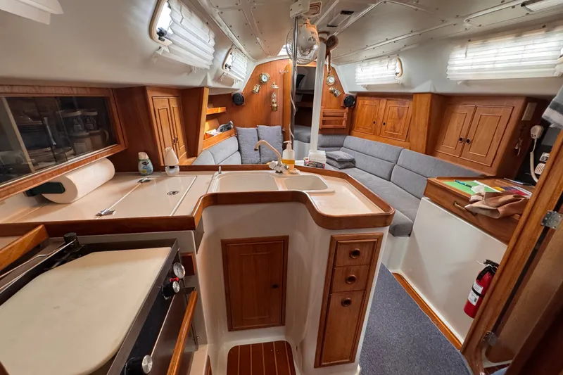 Slide: The Image of Interior of a 1991 CS 34 sailboat featuring a cozy kitchen and seating area. - 21