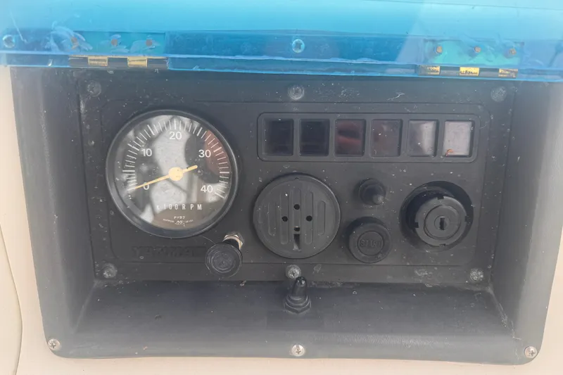 Slide: The Image of Control panel of a 1991 CS 34 boat with tachometer and ignition switch. - 19