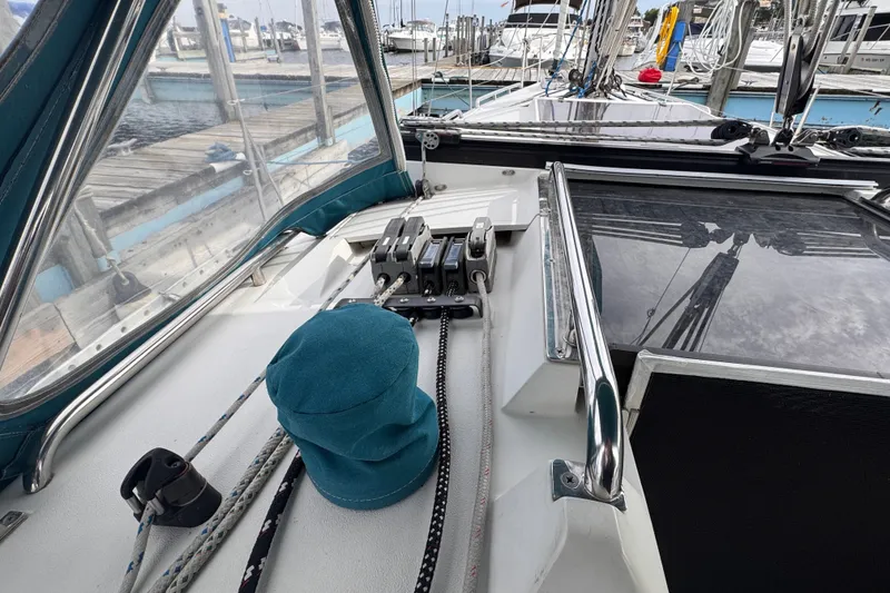 Slide: The Image of Cockpit view of a 1991 CS 34 sailboat with ropes and winches at a marina. - 13