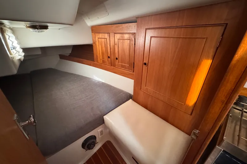 Slide: The Image of Cozy cabin interior of 1991 CS 34 sailboat with wooden cabinets and bed. - 26