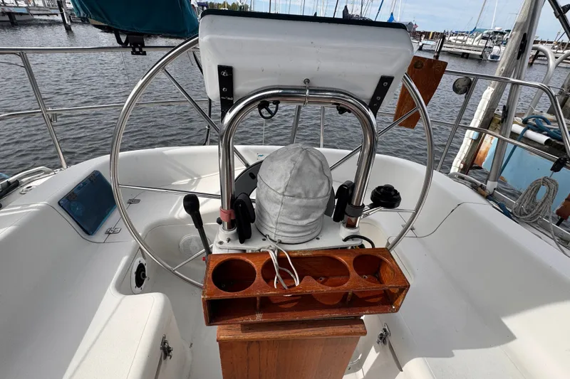 Slide: The Image of Cockpit of a 1991 CS 34 sailboat with steering wheel and wooden cup holder. - 16