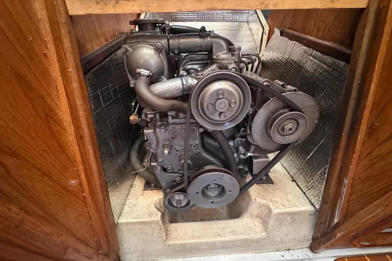 Slide: The Image of Engine compartment of a 1991 CS 34 sailboat, showcasing mechanical components and belts. - 37