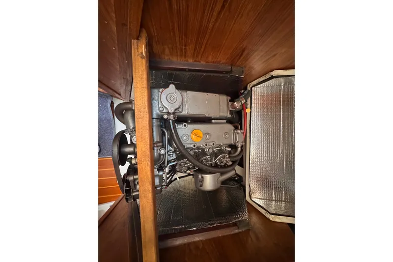 Slide: The Image of Engine compartment of a 1991 CS 34 sailboat, showcasing mechanical components and insulation. - 36