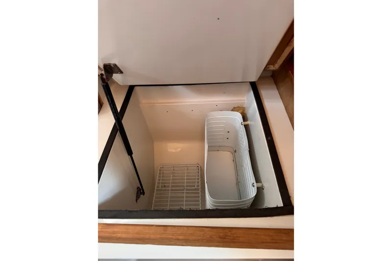 Slide: The Image of Open storage compartment in CS 34 model, 1991, with white basket and wire rack. - 32