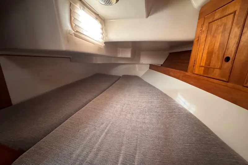 Slide: The Image of Cozy cabin interior of 1991 CS 34 sailboat with wooden cabinetry and soft lighting. - 27