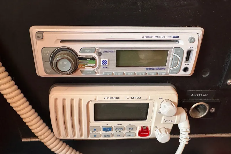 Slide: The Image of 1991 CS 34 boat radio and VHF marine communication system, featuring West Marine and Icom IC-M422. - 33
