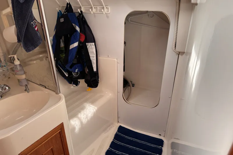 Slide: The Image of Small boat bathroom with sink, hanging jackets, and storage area, CS 34 model, 1991. - 29