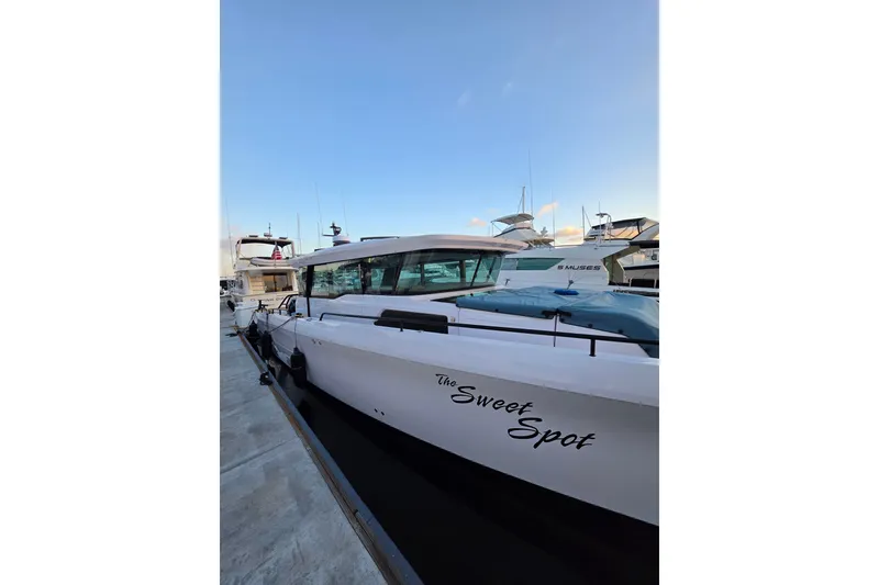 Slide: The Image of 2024 Axopar 45 XC Cross Cabin docked, featuring sleek design and modern aesthetics. - 19