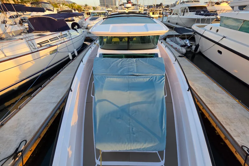 Slide: The Image of 2024 Axopar 45 XC Cross Cabin docked among luxury boats at marina. - 26