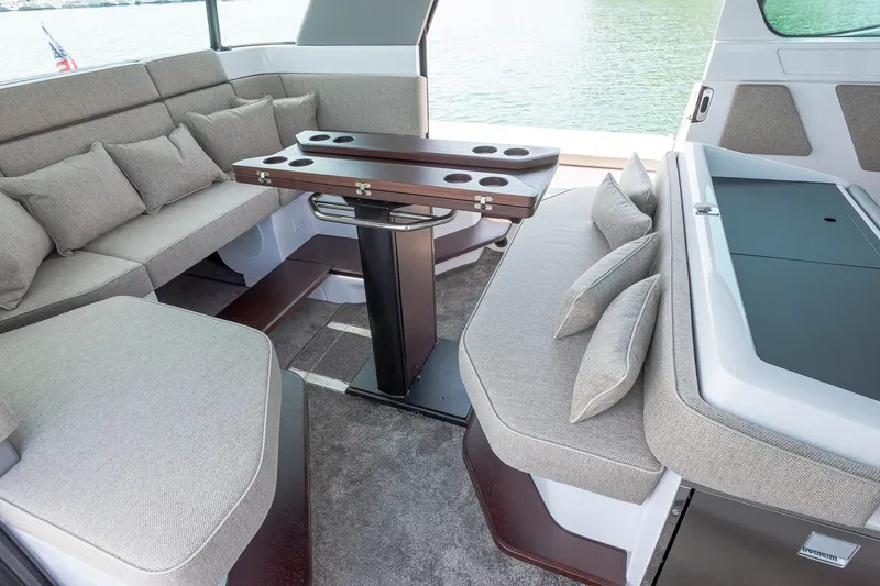Slide: The Image of Luxurious interior of 2024 Axopar 45 XC Cross Cabin with plush seating and elegant table. - 13