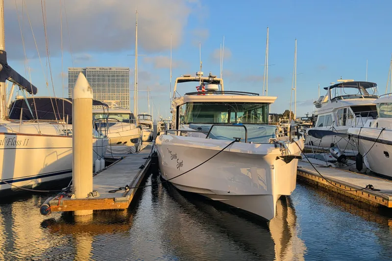 Slide: The Image of 2024 Axopar 45 XC Cross Cabin docked at marina during sunset. - 23