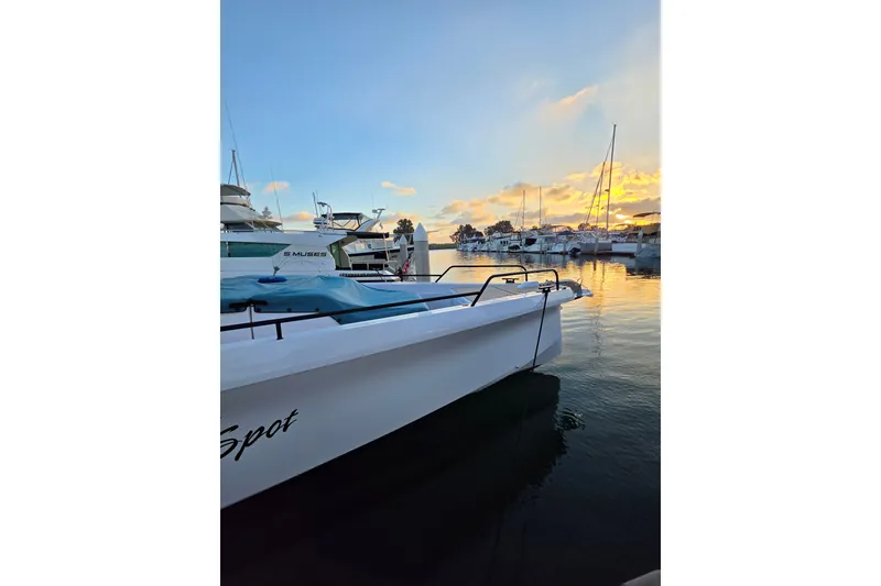 Slide: The Image of 2024 Axopar 45 XC Cross Cabin boat docked at sunset in a marina. - 21