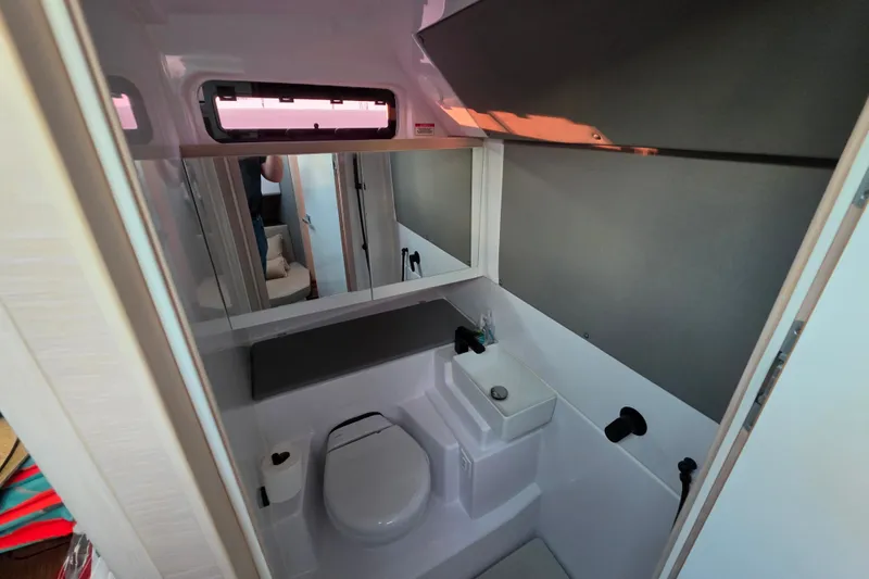 Slide: The Image of 2024 Axopar 45 XC Cross Cabin bathroom with modern fixtures and compact design. - 17
