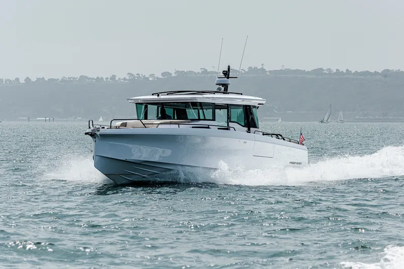 The Image of 2024 Axopar 45 XC Cross Cabin cruising on open water. - 1