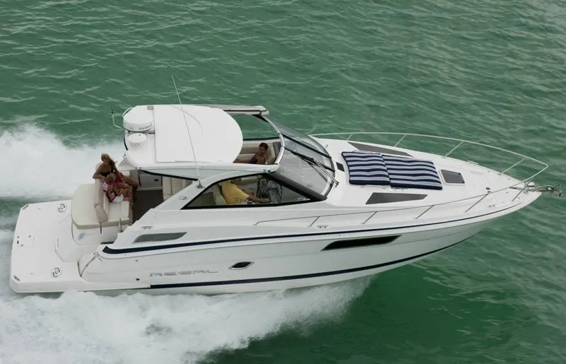 Slide: The Image of Manufacturer Provided Image: 2012 Regal 35 Sport Coupe cruising on the water with passengers onboard. - 35