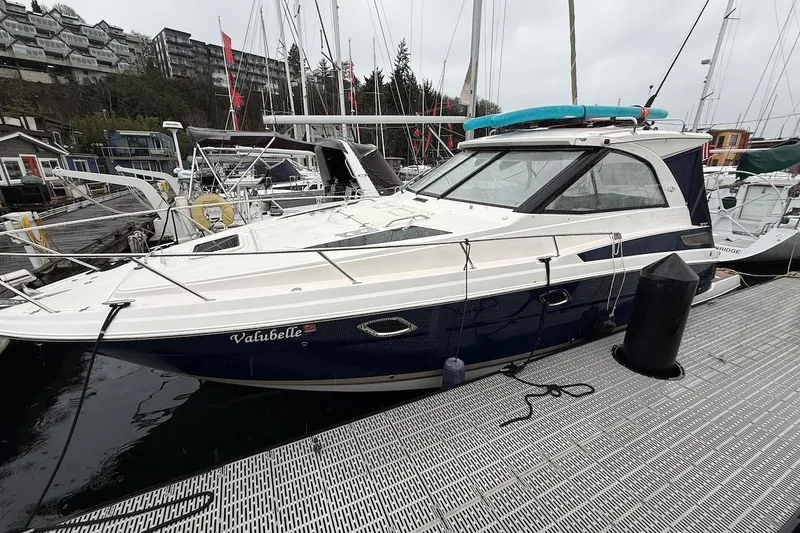 The Image of 2012 Regal 35 Sport Coupe docked at marina, overcast day. - 0