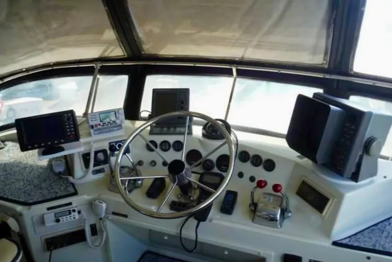 Slide: The Image of 1987 Tollycraft 44 Cockpit Motor Yacht helm with navigation equipment and steering wheel. - 5