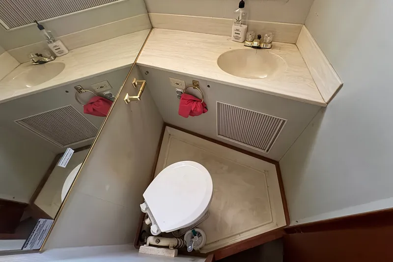 Slide: The Image of Bathroom interior of 1987 Tollycraft 44 Cockpit Motor Yacht, featuring sink and toilet. - 12